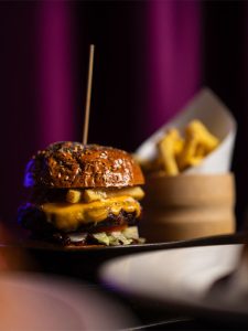 Cheeseburger with fries on side plate